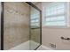 Shower with beige tile and glass door at 7928 S Giles Rd, Douglasville, GA 30135