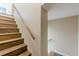 Wooden staircase with railing leading to upper level at 7928 S Giles Rd, Douglasville, GA 30135