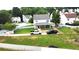 Backyard view of home featuring a covered porch, spacious lawn, and gravel driveway at 1087 Yellow River Dr, Lawrenceville, GA 30043