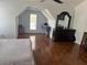 Spacious bedroom featuring hardwood floors, a ceiling fan, and natural light from the two windows at 1087 Yellow River Dr, Lawrenceville, GA 30043