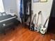 Bedroom featuring hardwood floors complete with a keyboard, three guitars, and a closet space at 1087 Yellow River Dr, Lawrenceville, GA 30043