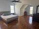 Spacious bedroom featuring hardwood floors, a ceiling fan, and natural light from the two windows at 1087 Yellow River Dr, Lawrenceville, GA 30043