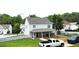 Exterior of two-story home with covered porch and gravel driveway in backyard at 1087 Yellow River Dr, Lawrenceville, GA 30043
