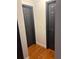 Hallway featuring hardwood floors with access to two rooms and light grey walls at 1087 Yellow River Dr, Lawrenceville, GA 30043