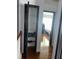 Hallway featuring hardwood floors with access to a closet and bedroom with an open dark wood door at 1087 Yellow River Dr, Lawrenceville, GA 30043