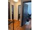 Hallway featuring hardwood floors with access to a bathroom and office with an open dark wood door at 1087 Yellow River Dr, Lawrenceville, GA 30043