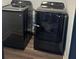 Updated laundry room with black washer and dryer sets and updated flooring at 1087 Yellow River Dr, Lawrenceville, GA 30043