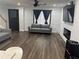 Modern living room features contemporary furnishings, recessed lighting, and stylish dark-toned accents for a sleek look at 1087 Yellow River Dr, Lawrenceville, GA 30043