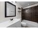 Bathroom featuring tiled shower and tub, a modern sink, and shelving at 135 E Hill St # 22, Decatur, GA 30030