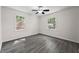 Bedroom with wood-look flooring, ceiling fan, and natural light from two windows at 135 E Hill St # 22, Decatur, GA 30030