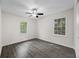 Bright bedroom with wood-look flooring, ceiling fan, and natural light from two windows at 135 E Hill St # 22, Decatur, GA 30030