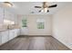 Charming kitchen with white cabinets, stainless steel sink and door leading to outside at 135 E Hill St # 22, Decatur, GA 30030