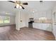 Open-concept kitchen with white cabinets, modern appliances, and views into the living area at 135 E Hill St # 22, Decatur, GA 30030