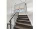 Neutral staircase with carpeted steps, black railing, and unit 22 door at 135 E Hill St # 22, Decatur, GA 30030