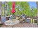 Back deck featuring a table, chairs, and a grill with views of the wooded yard at 403 Rustic Ridge Cir, Lawrenceville, GA 30043