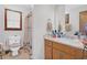 Bathroom features neutral walls, carpet, a window, and a wood vanity at 403 Rustic Ridge Cir, Lawrenceville, GA 30043