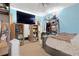 This bedroom features light blue walls, a ceiling fan, and a large TV at 403 Rustic Ridge Cir, Lawrenceville, GA 30043