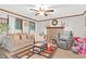 Comfortable living room with a stone fireplace, plush seating, and natural light, perfect for relaxation at 403 Rustic Ridge Cir, Lawrenceville, GA 30043