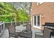 Relax on the expansive back deck perfect for entertaining with outdoor kitchen area and lounge furniture at 515 Old Chartwell Xing, Alpharetta, GA 30022
