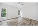 Large bedroom with hardwood floors, natural light, and scenic outdoor views at 515 Old Chartwell Xing, Alpharetta, GA 30022