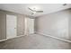 Bedroom features neutral paint, ceiling fan, two windows, and closet spaces at 515 Old Chartwell Xing, Alpharetta, GA 30022
