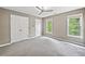 Spacious bedroom with neutral walls, plush carpet, ceiling fan, and natural light from dual windows at 515 Old Chartwell Xing, Alpharetta, GA 30022