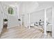 Grand foyer with staircase and classic columns opens into a light-filled living space at 515 Old Chartwell Xing, Alpharetta, GA 30022