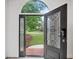 Elegant front door with decorative glass and sidelights, providing a glimpse of the landscaped yard at 515 Old Chartwell Xing, Alpharetta, GA 30022