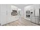 Modern kitchen with white cabinetry, stainless steel appliances, and wood-style flooring at 515 Old Chartwell Xing, Alpharetta, GA 30022