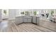 Open concept kitchen features a stainless steel sink and view to living room at 515 Old Chartwell Xing, Alpharetta, GA 30022