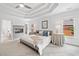 Primary bedroom with a tray ceiling, fireplace, and an ensuite bathroom at 515 Old Chartwell Xing, Alpharetta, GA 30022