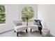 Cozy sitting area with decorative chairs, side table, and a large arched window at 515 Old Chartwell Xing, Alpharetta, GA 30022
