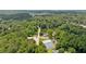 Scenic aerial view of a community lake with a pool and tennis courts at 890 Lake Dr, Snellville, GA 30039