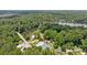 Aerial view of community featuring sparkling pool, tennis courts, and lake access amid lush greenery at 890 Lake Dr, Snellville, GA 30039