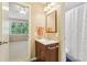Bright bathroom with a wood vanity, white sink, and a tub and shower combo at 890 Lake Dr, Snellville, GA 30039