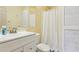 Full bathroom with shower, toilet, vanity and white wooden panels at 890 Lake Dr, Snellville, GA 30039