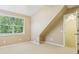 Neutral bonus room featuring carpeted floors, angled ceiling and natural light at 890 Lake Dr, Snellville, GA 30039