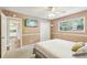 Comfortable bedroom featuring neutral walls, carpet, ceiling fan, and a view to the kitchen at 890 Lake Dr, Snellville, GA 30039