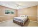 Cozy bedroom featuring neutral walls, carpet, ceiling fan, and a comfortable bed at 890 Lake Dr, Snellville, GA 30039