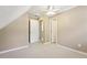 Neutral bonus room featuring carpeted floors, angled ceiling and two closets at 890 Lake Dr, Snellville, GA 30039