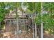 Multi-level lake house with multiple decks surrounded by mature trees creating a secluded oasis at 890 Lake Dr, Snellville, GA 30039