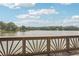 Scenic lake view from a wood deck with charming railing and sparkling water under a blue, cloudy sky at 890 Lake Dr, Snellville, GA 30039