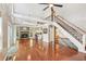 Open-concept living room with a cozy fireplace, staircase, and hardwood floors, creating an inviting space at 890 Lake Dr, Snellville, GA 30039