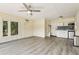 Bright living room with wood-look floors, kitchenette, stainless steel appliances, and natural light at 890 Lake Dr, Snellville, GA 30039