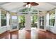 Bright sunroom with wood floors and deck access with views of the lake and landscape at 890 Lake Dr, Snellville, GA 30039