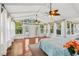 Bright sunroom with wood floors, ceiling fans, lots of windows and deck access at 890 Lake Dr, Snellville, GA 30039