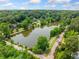 Scenic aerial shot of a tranquil lake surrounded by lush greenery and homes at 1138 Berkeley Rd, Avondale Estates, GA 30002