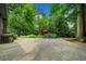 Large backyard with mature trees, a swing set, and a stone patio at 1138 Berkeley Rd, Avondale Estates, GA 30002