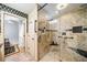 Modern bathroom featuring a glass-enclosed shower with stone tile and a grab bar at 1138 Berkeley Rd, Avondale Estates, GA 30002