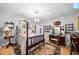 Bedroom featuring a chandelier, a four-poster bed, and hardwood floors at 1138 Berkeley Rd, Avondale Estates, GA 30002